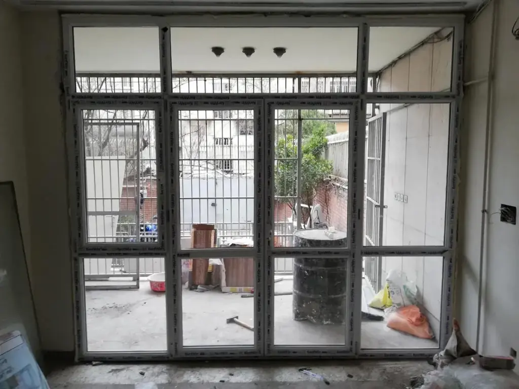 دیوار شیشهای رو به حیاط با درب دولنگه و پنجرههای ثابت UPVC